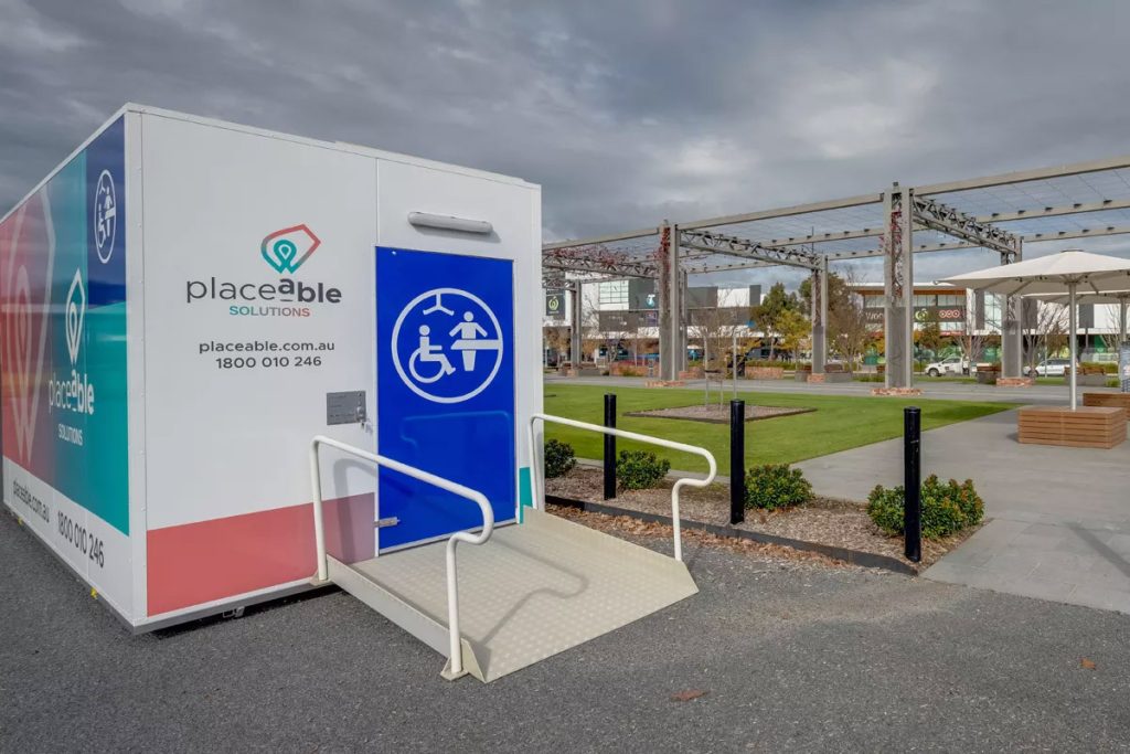 Placeable accessible Changing Places pod installed in a public park, with wheelchair ramp and handrail